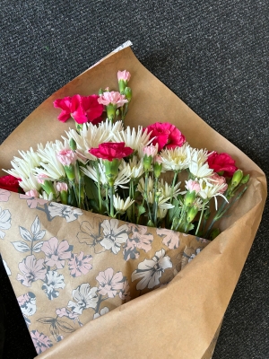 Flowers wrapped in shop paper