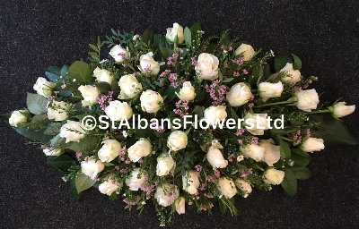 All white rose and pink wax flower coffin spray