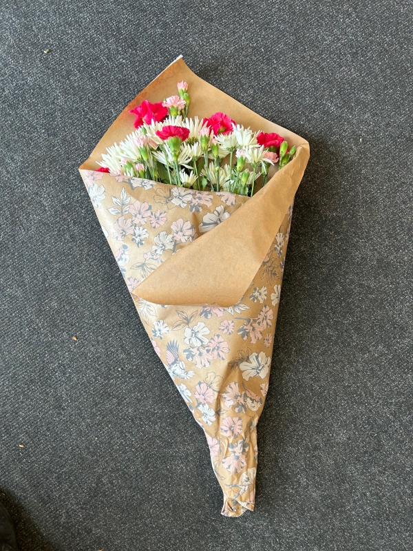 Flowers wrapped in shop paper