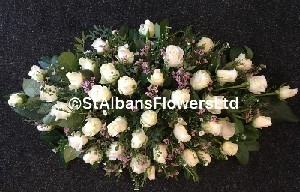 All white rose and pink wax flower coffin spray