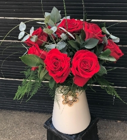 Dozen red roses in a vase