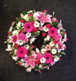 Cerise and white loose wreath including lilies